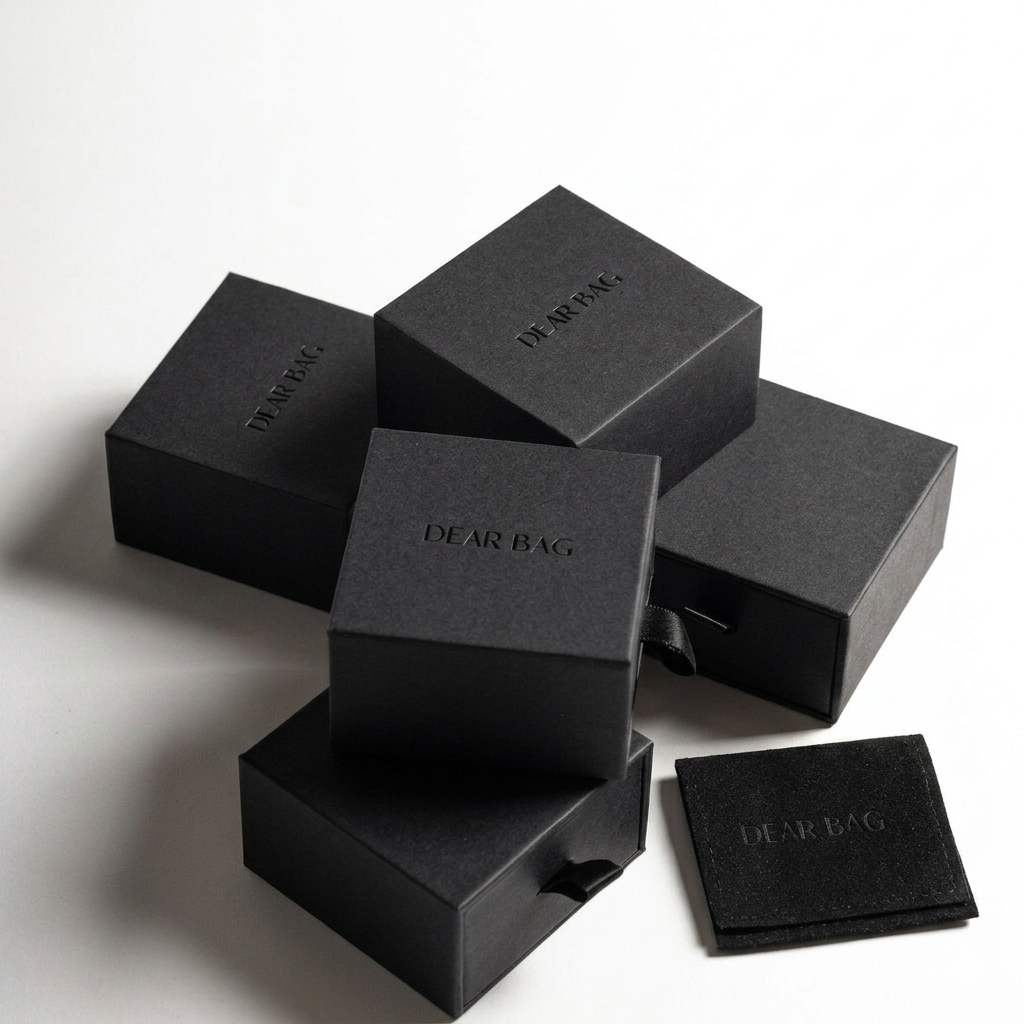 Stack of black boxes with 'DEAR BAG' branding on a white background