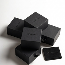 Stack of black boxes with 'DEAR BAG' branding on a white background